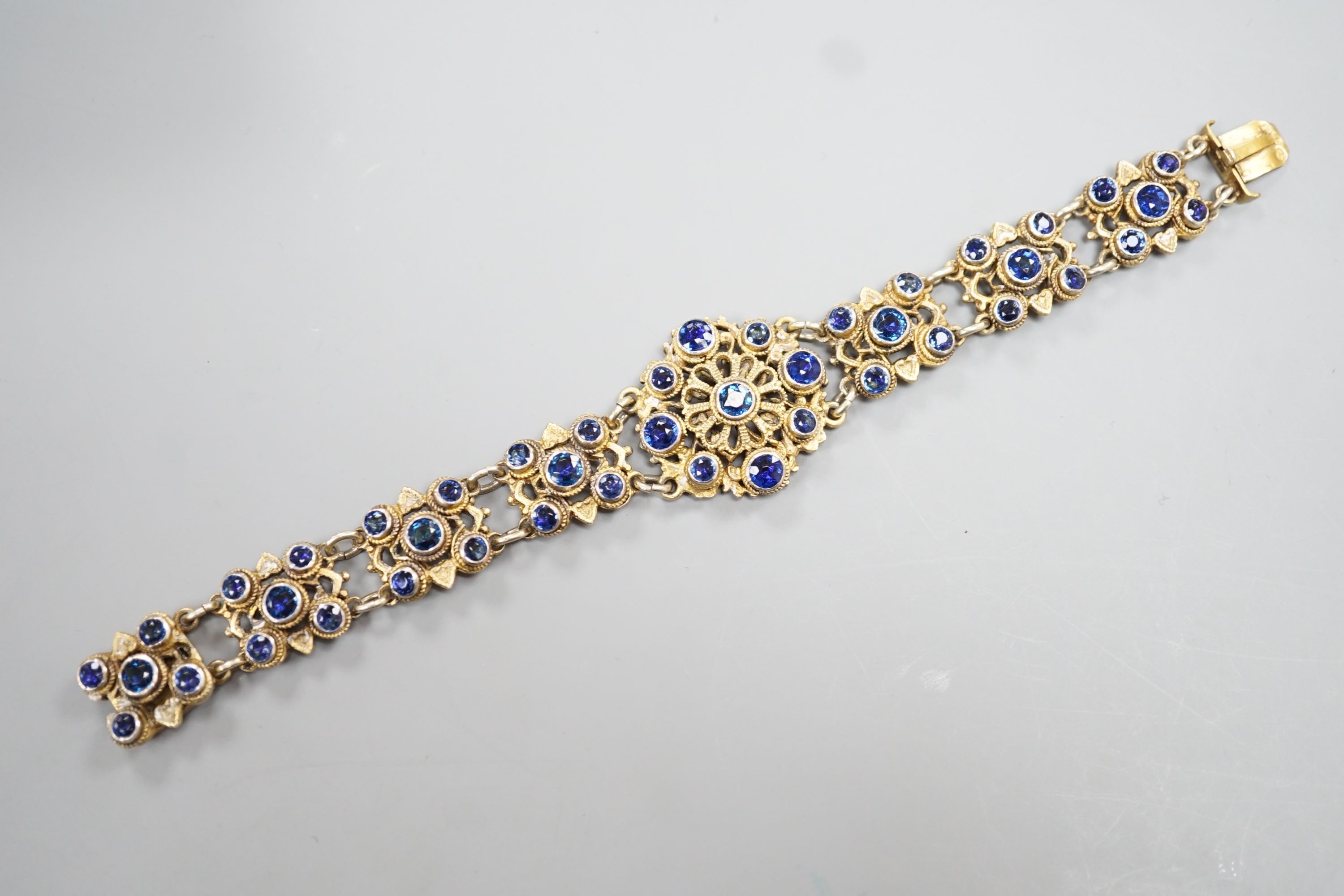 A late 19th/early 20th century Austro-Hungarian gilt white metal and blue paste set bracelet, 15.8cm.